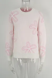 Pink long sleeve knit sweater with white floral outline pattern for casual spring wear