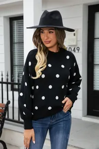 Stylish black knit sweater with white polka dots featuring a crew neck and puff sleeves.