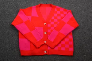 Full view of women's red and pink checkerboard patchwork knit cardigan with buttons