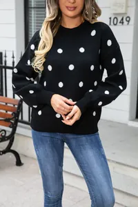 Stylish black knit pullover sweater featuring white polka dot pattern and crew neck