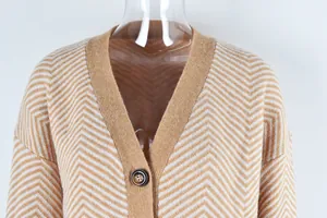 Detail shot of women's V-neck knit cardigan with camel and white chevron pattern.