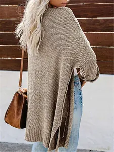Seitenansicht eines beigefarbenen Long-Strickcardigans in Übergröße mit Seitenschlitzen.