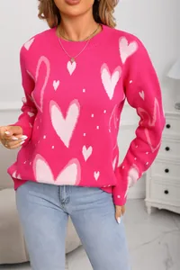 Close-up of a hot pink women's knit sweater with light pink heart pattern details