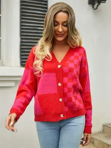 Detailed view of women's red and pink checkered patchwork knit cardigan sweater