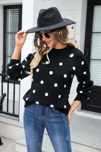 Casual black polka dot knitted sweater for women styled with a hat and jeans.