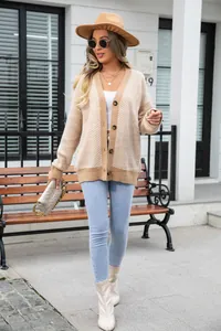 Full body street shot of a model wearing a chevron knit cardigan with beige hat and jeans