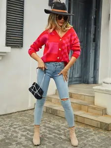 Detailed view of a red and pink checkered knit cardigan worn by a fashion model