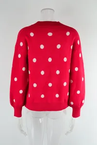Detail showing the back view of a red polka dot knit pullover sweater on mannequin