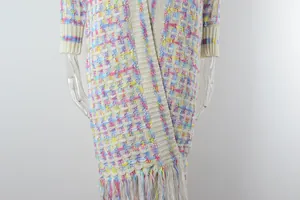 Close-up detail of colorful checkered knit long cardigan with boho fringe tassels