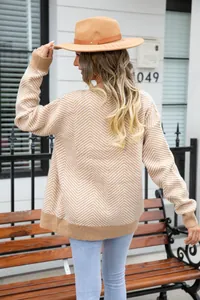 Back view of women's oversized knit cardigan with beige and white zigzag stripes