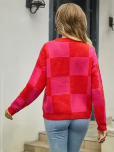 Detailed back view of a vibrant red and pink checkered knit sweater for women outdoors