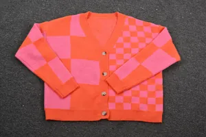 Detailed view of pink and orange checkerboard patchwork on women's knit cardigan
