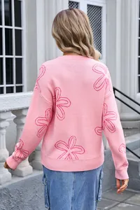 Back view of pink knit sweater with oversized floral patterns and a crew neckline