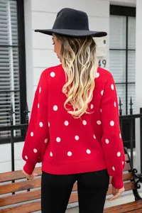 Back view of a red knit pullover sweater with white polka dots for women