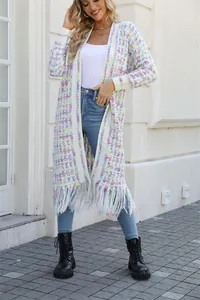 Full length view of a cozy long knit cardigan with fringe hem and colorful plaid pattern