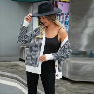 Stylish black and white chevron knit cardigan with white ribbed trim and button front.