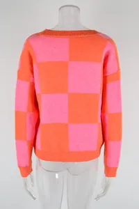 Back view detail of a vibrant pink and orange checkerboard pattern knit sweater