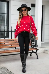 Stylish outdoor street photography of a woman in a red polka dot knit pullover sweater.