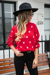 Stylish woman wearing red polka dot pullover knit sweater outdoors