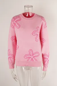Close-up view of a pink long-sleeved crewneck sweater featuring hot pink floral patterns.