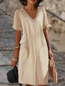 Elegant beige cotton linen V-neck dress featuring unique neckline embroidery and side pockets