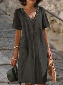 Front view of summer cotton linen V-neck dress with decorative neckline and side pockets