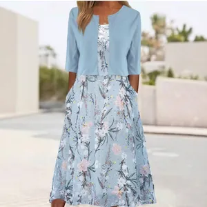Elegant light blue floral maxi dress featuring a matching short cardigan for a graceful look