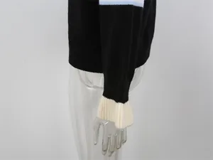 Gros plan sur la manche d'un cardigan rayé en maille avec détail de poignet côtelé