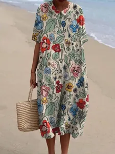 Detailweergave van een bloemen maxi-jurk met elegante poppenkraag op het strand