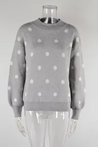 Close-up detail of gray knit pullover sweater featuring white polka dots on a mannequin torso