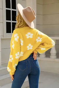 Suéter de punto amarillo con flores blancas para un look de otoño elegante y moderno.
