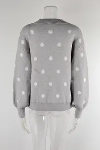 Rear view detail of a gray knitted pullover sweater featuring white polka dot patterns.