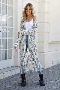 Professional model wearing a long grey and white plaid knitted cardigan with fringe