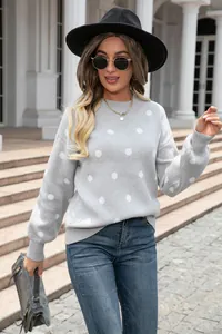 Detail shot of light gray sweater with white polka dot pattern and ribbed cuffs