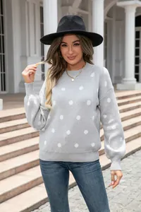 Stylish women's grey polka dot crew neck knit sweater shown in an outdoor lifestyle setting