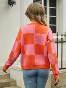 Detailed back view of a women's oversized orange and pink checkered knit sweater