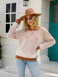 Detailed view of women's fuzzy brown chevron knit sweater worn with stylish hat