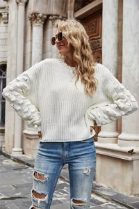 White knitted pullover with textured bubble sleeves on a blonde fashion model