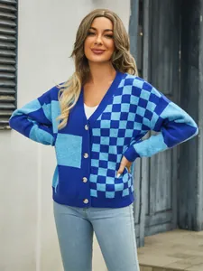 Full view of a women's blue checkerboard patchwork knit cardigan with white buttons.
