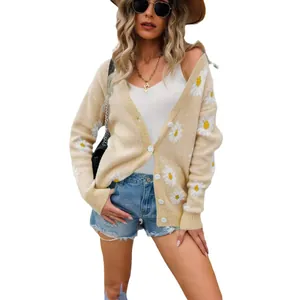 Beige oversized cardigan with floral daisy prints and white buttons for casual look