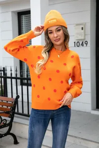 Women's casual orange polka dot knit sweater with matching bright orange beanie hat
