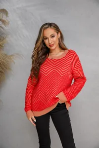 Detailed view of women's red and tan chevron pattern long sleeve knit sweater on model