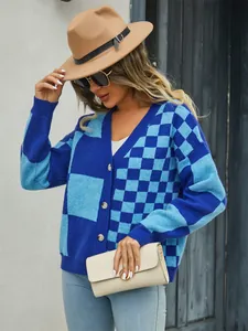 Chic women's blue checkered patchwork knitted cardigan sweater shown in a stylish outdoor setting