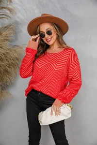 Close-up detail of women's red zigzag fuzzy knit sweater featuring a cozy crew neck