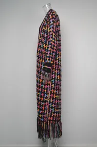 Side profile of a colorful plaid knit long cardigan featuring a decorative fringe hem