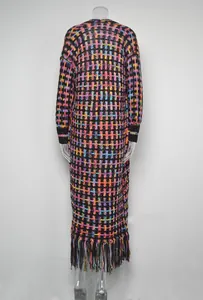 Detailed rear view of a long colorful knit cardigan featuring a tassel fringe hem.