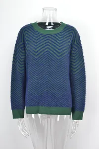 Detailed view of women's long sleeve crewneck sweater with green and purple chevron pattern