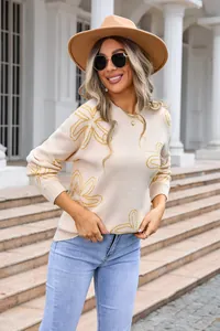 Chic crew neck knit sweater featuring elegant yellow flower pattern on cream base.