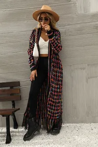 Detailed view of women's long knit cardigan with vibrant colorful plaid and tassel fringe