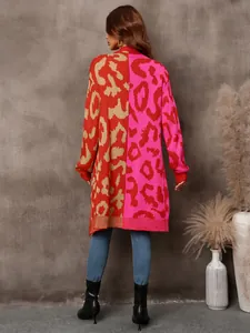 Back view of a long-line leopard print knit cardigan with pink and red color block design